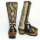 Front view of artisan snake skin boots with feathers, shells and horn ornaments