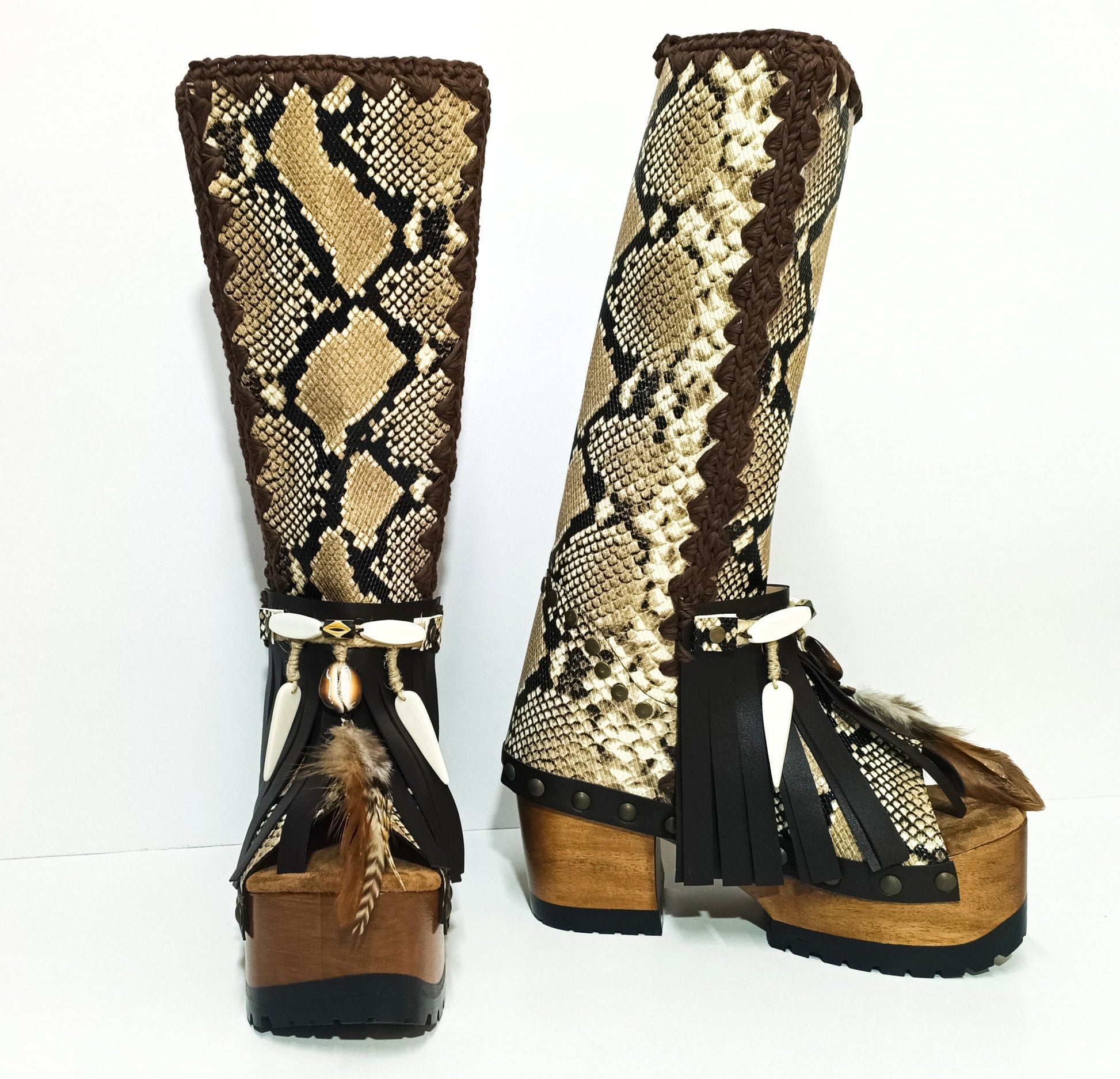 Front view of artisan snake skin boots with feathers, shells and horn ornaments