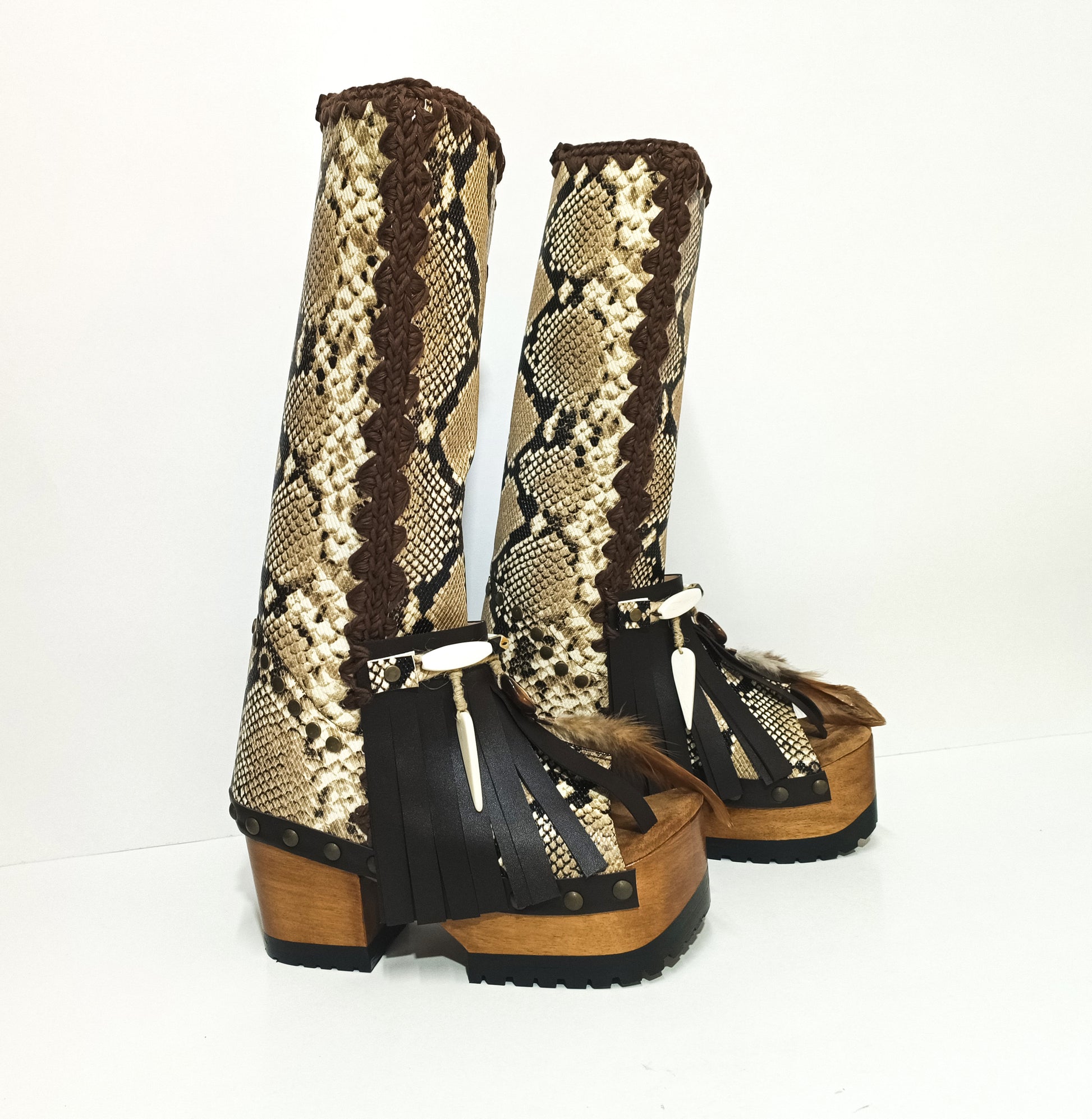 Side view of handcrafted snake leather boots showing lacquered wooden platform and tractor rubber sole