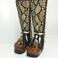 Close-up of wooden platform sole and antique gold studs on handcrafted bohemian snake leather boots