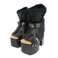 Sol Caleyo handmade platform sandals in genuine full-grain leather with wood sole and 12cm heel. Featuring silver conchos, black stones, and tractor rubber sole. Bohemian luxury footwear.