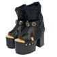 Sol Caleyo handmade platform sandals in genuine full-grain leather with wood sole and 12cm heel. Featuring silver conchos, black stones, and tractor rubber sole. Bohemian luxury footwear.