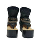 Sol Caleyo Texas Boots: Handcrafted black leather platform flip-flop sandals with wooden wedge heel, silver pyramid studs, and decorative chains. 9cm heel with zig-zag rubber traction sole.