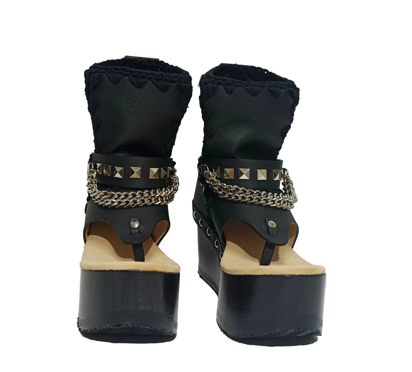 Sol Caleyo Texas Boots: Handcrafted black leather platform flip-flop sandals with wooden wedge heel, silver pyramid studs, and decorative chains. 9cm heel with zig-zag rubber traction sole.