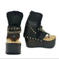 Sol Caleyo Texas Boots: Handcrafted black leather platform flip-flop sandals with wooden wedge heel, silver pyramid studs, and decorative chains. 9cm heel with zig-zag rubber traction sole.
