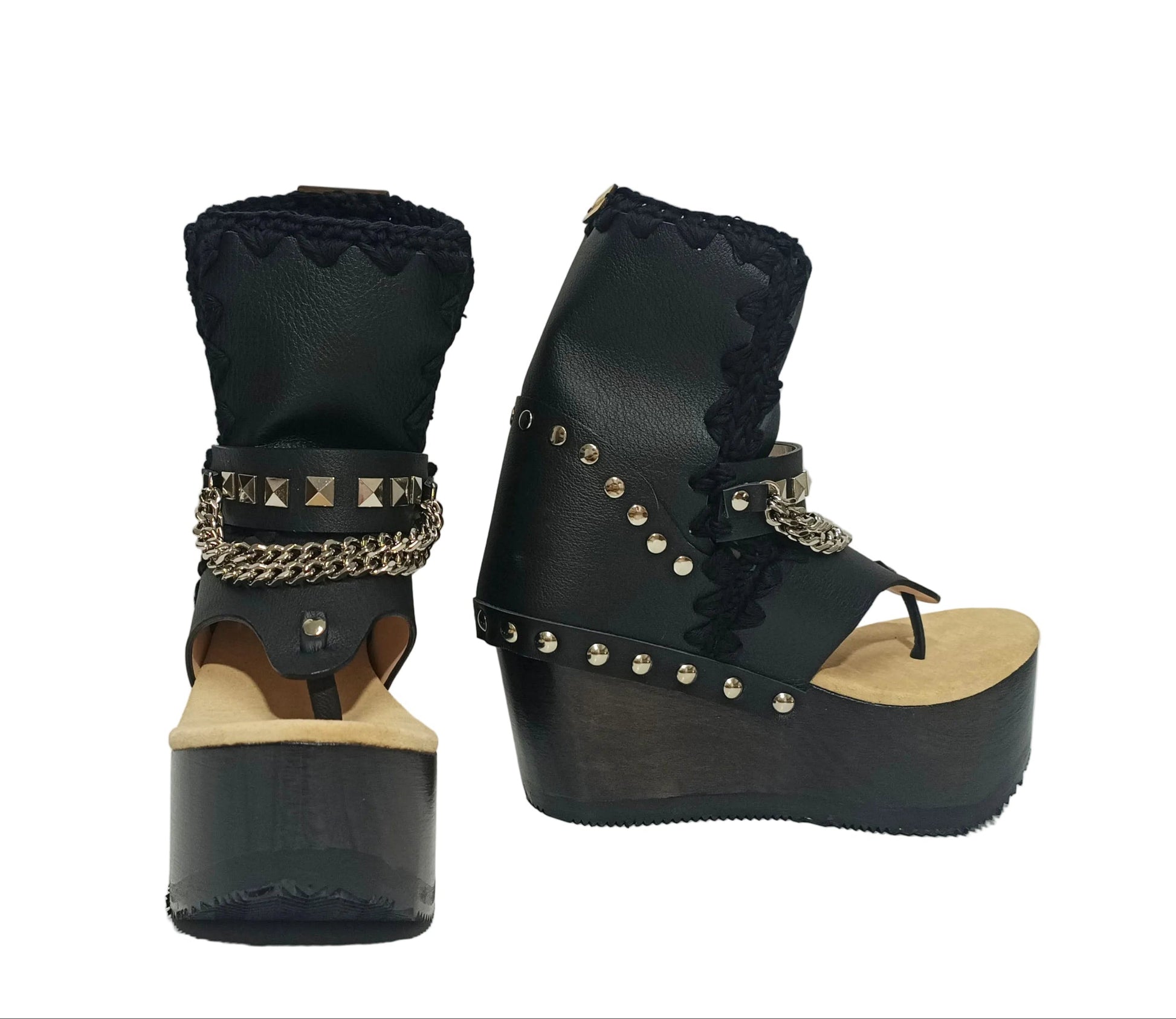 Sol Caleyo Texas Boots: Handcrafted black leather platform flip-flop sandals with wooden wedge heel, silver pyramid studs, and decorative chains. 9cm heel with zig-zag rubber traction sole.