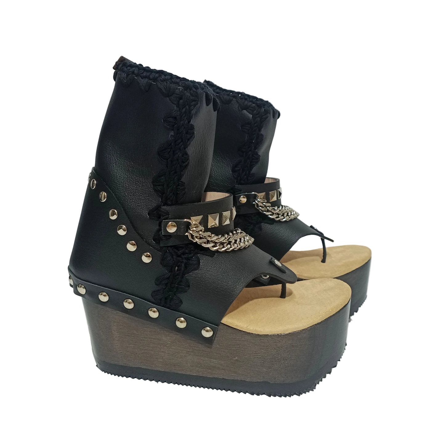 Sol Caleyo Texas Boots: Handcrafted black leather platform flip-flop sandals with wooden wedge heel, silver pyramid studs, and decorative chains. 9cm heel with zig-zag rubber traction sole.