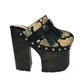 Indian Snake Clogs by Sol Caleyo: extreme 18cm straight heel wooden platforms with snake-print leather, black fringe, and Native American style metal conchos.