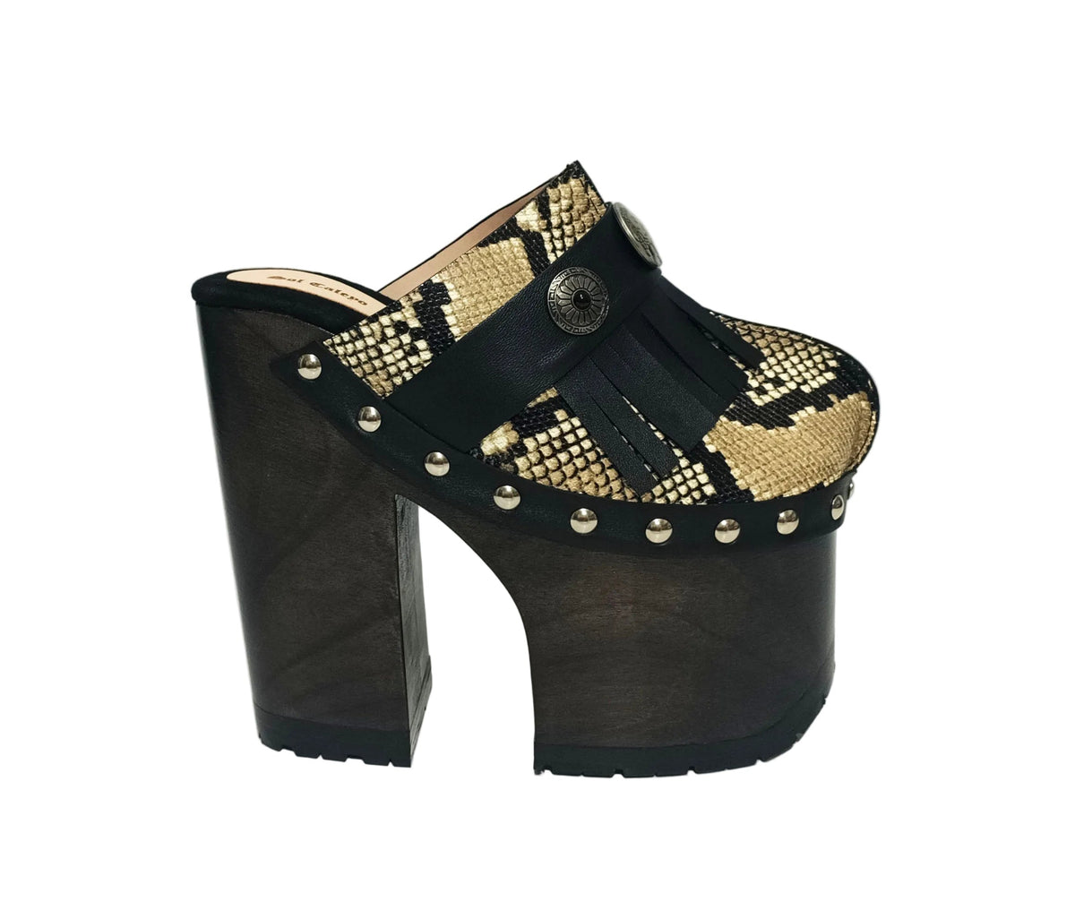 Indian Snake Clogs by Sol Caleyo: extreme 18cm straight heel wooden platforms with snake-print leather, black fringe, and Native American style metal conchos.