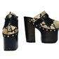 Indian Snake Clogs by Sol Caleyo: extreme 18cm straight heel wooden platforms with snake-print leather, black fringe, and Native American style metal conchos.