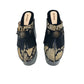 Indian Snake Clogs by Sol Caleyo: extreme 18cm straight heel wooden platforms with snake-print leather, black fringe, and Native American style metal conchos.
