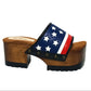 American Sandals XS by Sol Caleyo: close-up of handmade wooden platform sandals with USA flag leather strap and studs.