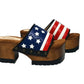 American Sandals XS by Sol Caleyo: close-up of handmade wooden platform sandals with USA flag leather strap and studs.