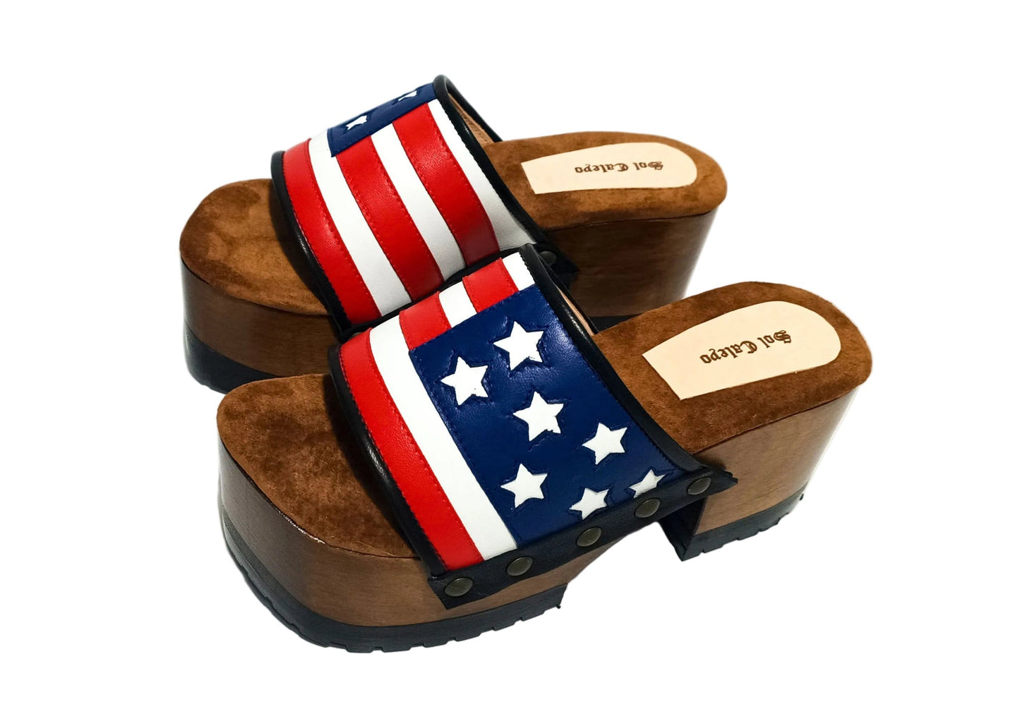 American Sandals XS by Sol Caleyo: close-up of handmade wooden platform sandals with USA flag leather strap and studs.