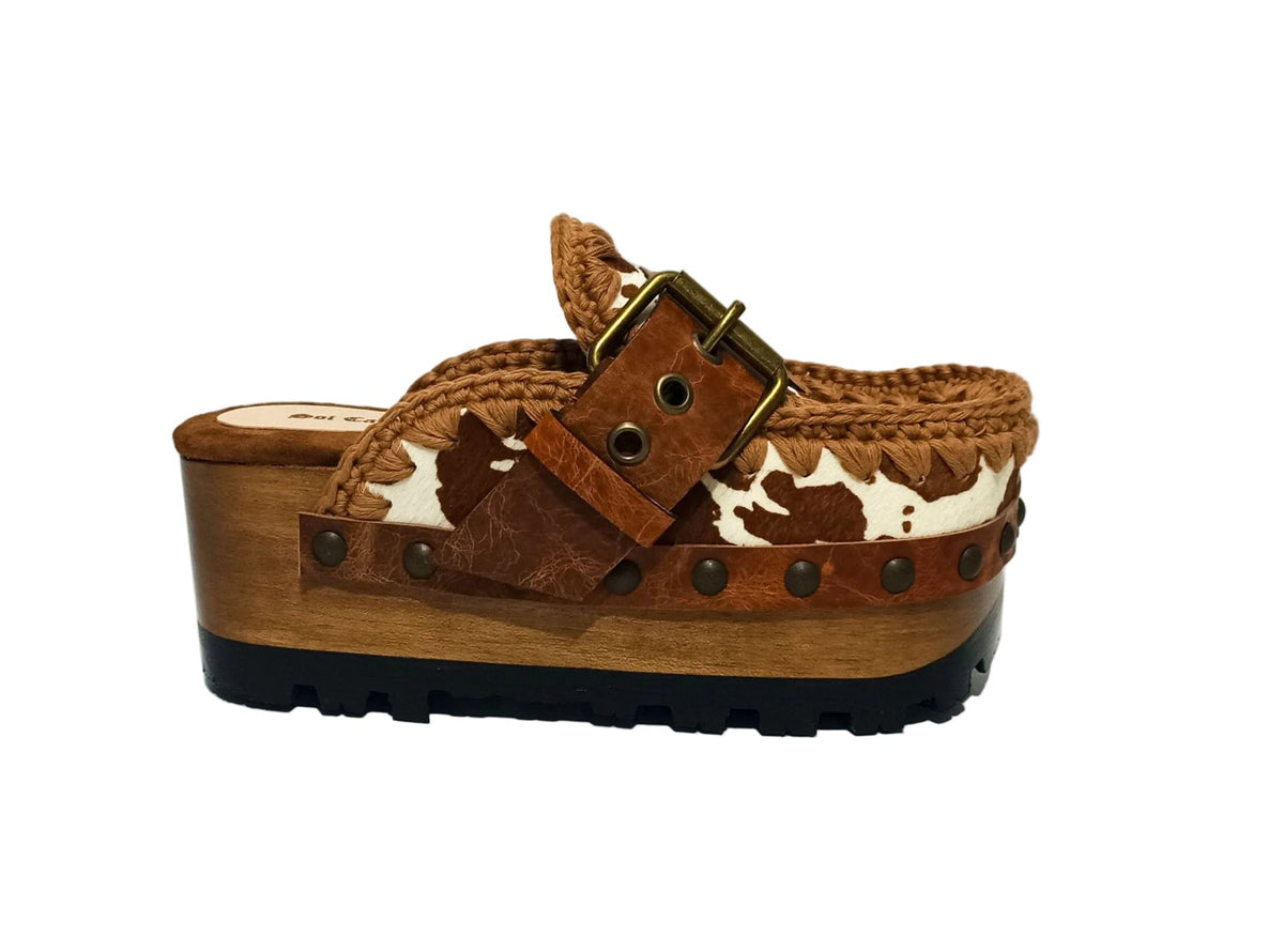 Oxford Clogs Cowhide Print by Sol Caleyo: handmade wooden platform clogs with cowhide hair-on leather, crochet trim, and aged camel leather strap.