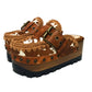 Oxford Clogs Cowhide Print by Sol Caleyo: handmade wooden platform clogs with cowhide hair-on leather, crochet trim, and aged camel leather strap.
