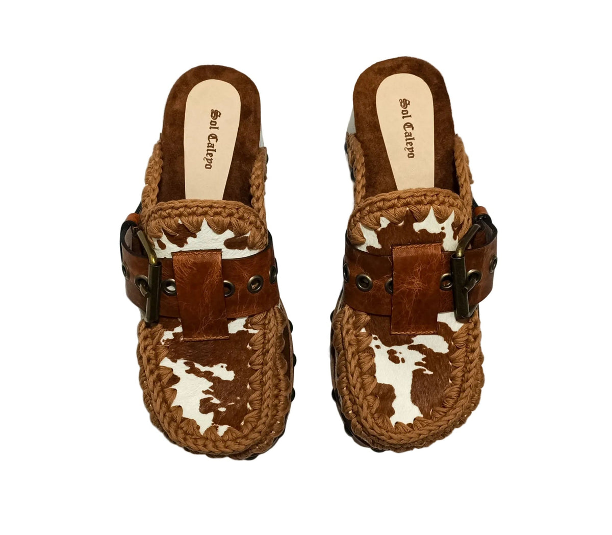 Oxford Clogs Cowhide Print by Sol Caleyo: handmade wooden platform clogs with cowhide hair-on leather, crochet trim, and aged camel leather strap.