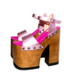 Handmade Crazy Pink metallic leather platform sandals by Sol Caleyo featuring old gold studs, a dark wood platform, and an 17 cm heel on a white background.