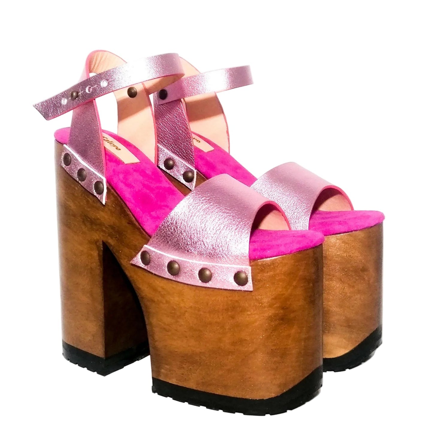 Handmade Crazy Pink metallic leather platform sandals by Sol Caleyo featuring old gold studs, a dark wood platform, and an 17 cm heel on a white background.