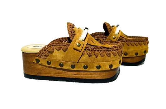 Moccasin style suede leather clogs, decorated with fringes and horns. Moccasin style leather mules. High-end footwear handmade by Sol Caleyo.