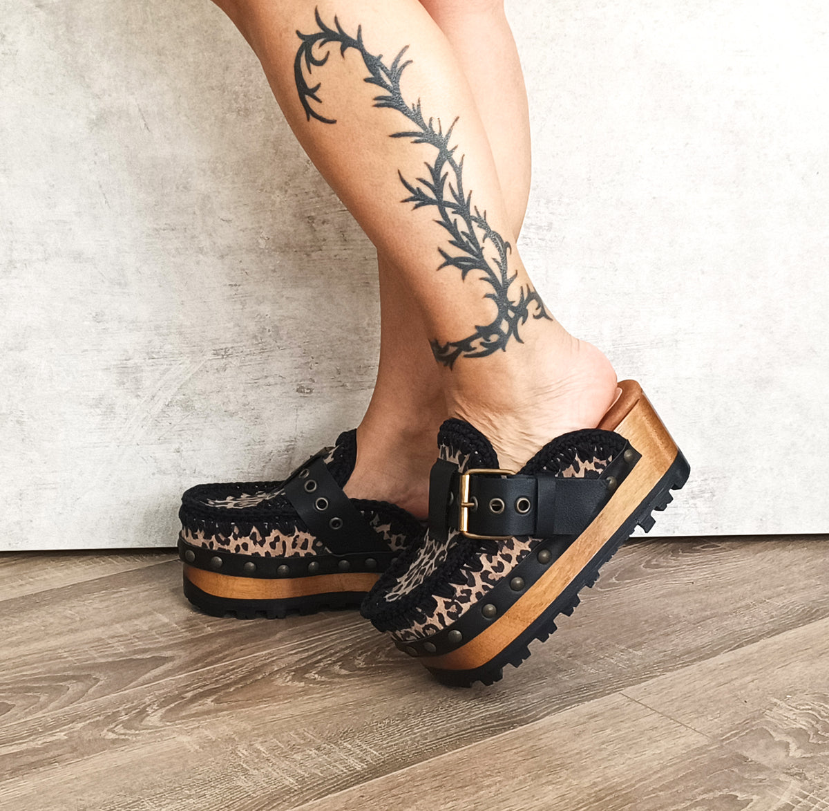 Handmade leopard print leather wedge mule clogs with old-gold buckle, studs and 6 cm wooden wedge by Sol Caleyo.