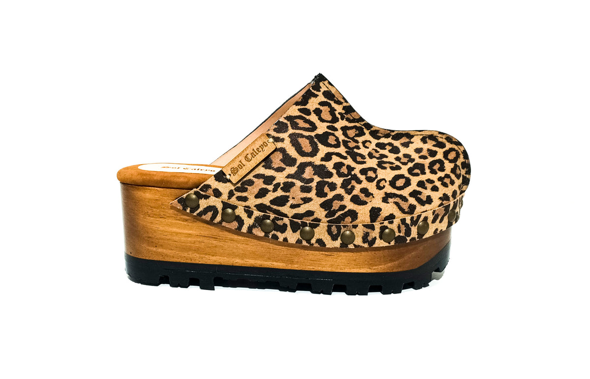 Handmade leopard print split leather wedge mule clogs with antique-gold studs and 7 cm wooden wedge by Sol Caleyo.