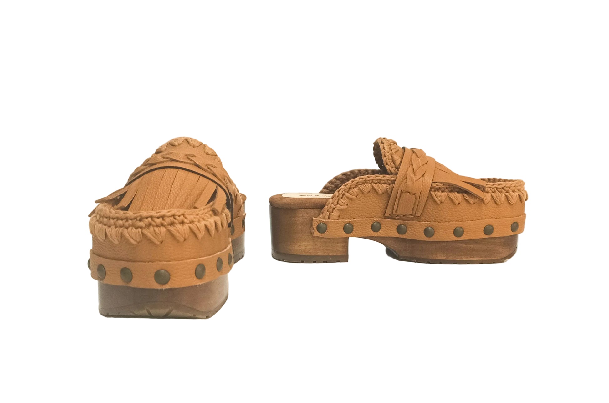 Side profile of Sol Caleyo Niza Clogs in light brown leather, showcasing hand-braided strap, crochet trim, bronze studs, and a sturdy wooden platform sole.
