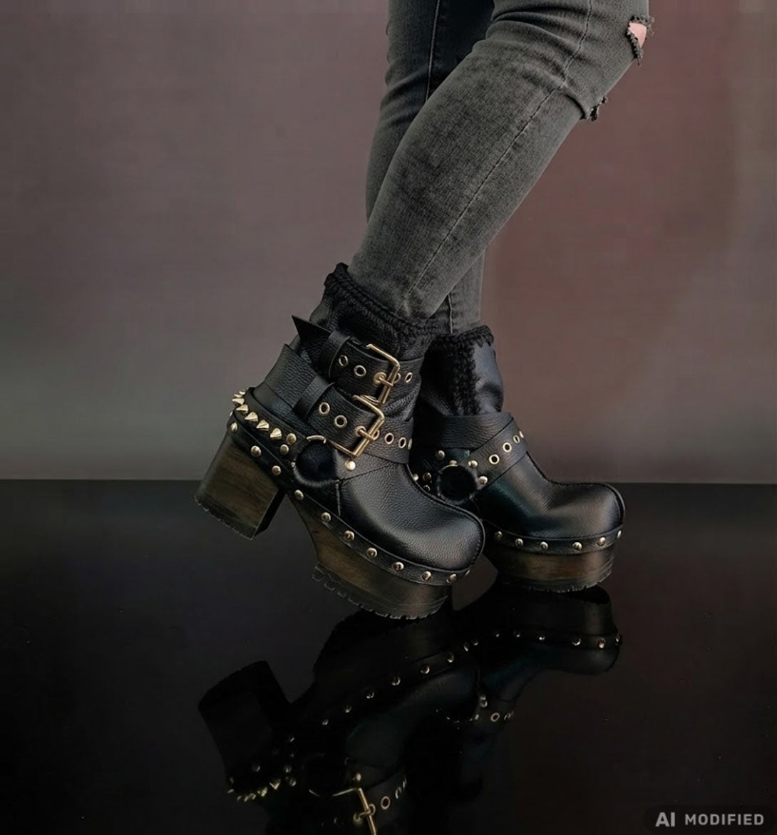 Black leather platform boots with silver studs. Black leather biker style boots with buckles. Black leather ankle boots with vintage style buckles. Leather boots with wooden heel. High-end handmade footwear by Sol Caleyo.