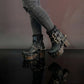 Black leather platform boots with silver studs. Black leather biker style boots with buckles. Black leather ankle boots with vintage style buckles. Leather boots with wooden heel. High-end handmade footwear by Sol Caleyo.
