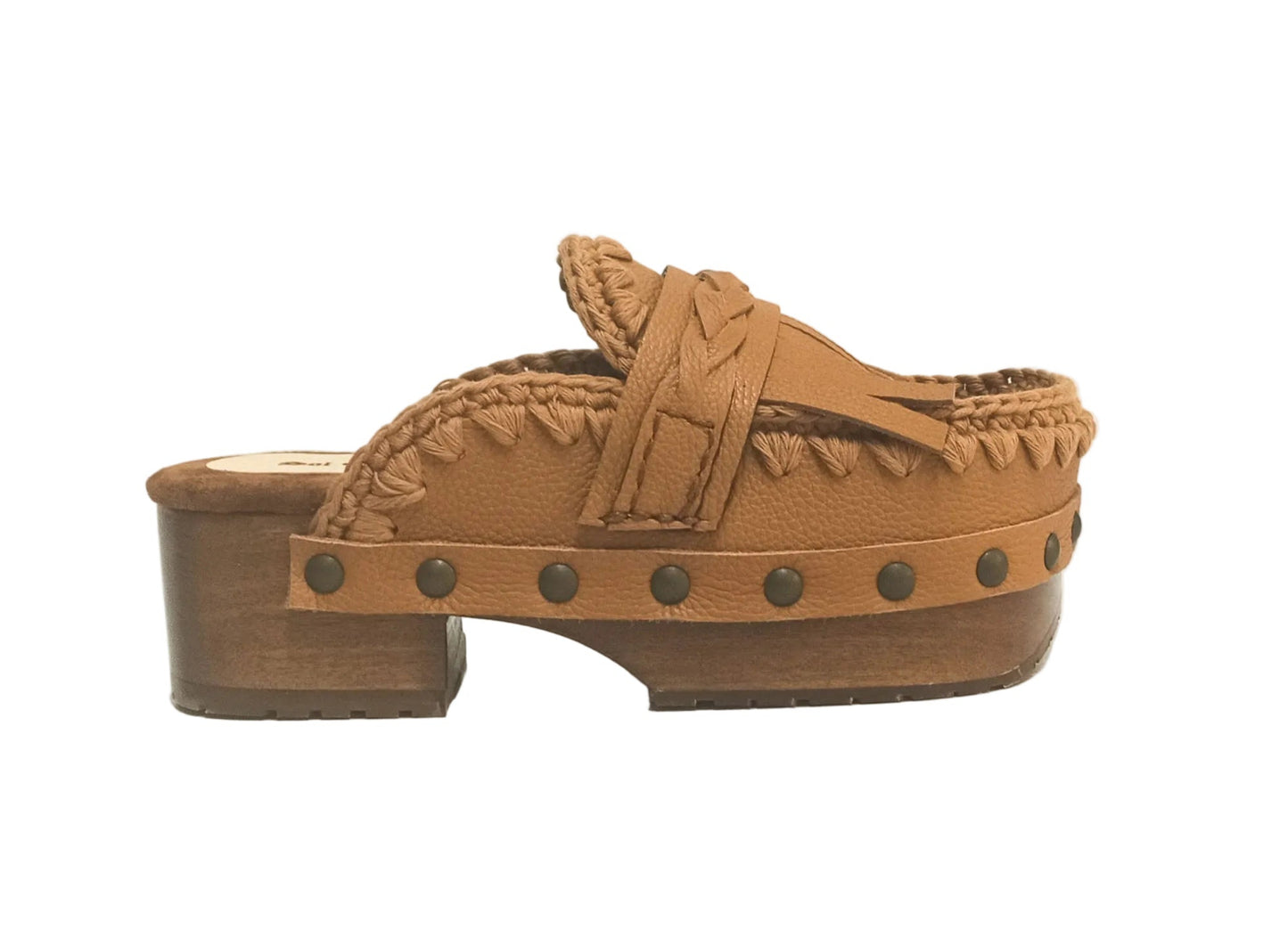 Side profile of Sol Caleyo Niza Clogs in light brown leather, showcasing hand-braided strap, crochet trim, bronze studs, and a sturdy wooden platform sole.