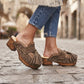 Model wearing Artemisa Earth Tone Suede Tassel Clogs with wooden platform and crochet details outdoors