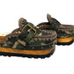 Handcrafted military camouflage and brown leather platform clog with unique crochet stitch edging and antique gold buckle detailing on a sturdy wooden base with a rugged black rubber outsole.