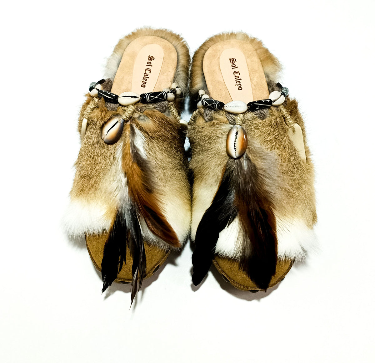 Handmade boho suede platform clogs with rabbit fur, carved bone, shells and feathers by Sol Caleyo