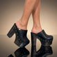 Black leather clogs with platform and super high heel. Leather mule with super high wooden heel. Black leather clogs 70's vintage style. Vintage style super high heel clogs. Sizes 34 to 47. High quality leather shoes handmade by sol Caleyo. Sustainable fashion.