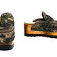 Handcrafted military camouflage and brown leather platform clog with unique crochet stitch edging and antique gold buckle detailing on a sturdy wooden base with a rugged black rubber outsole.