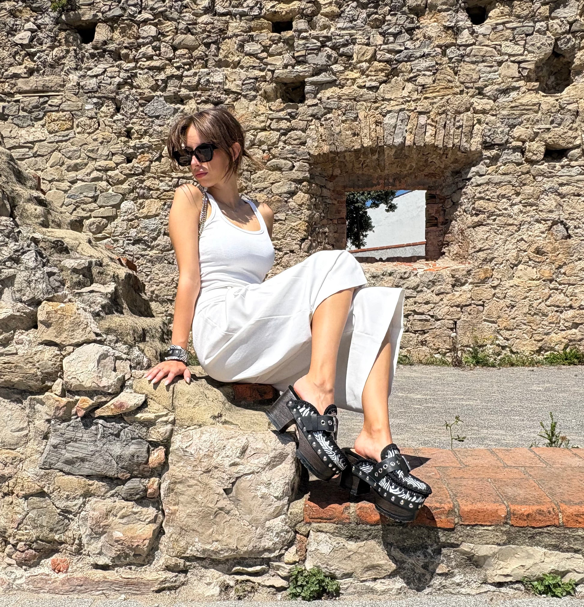Zebra leather mules with wooden heels. Zebra clogs made from premium quality leather. High-end footwear handmade by Sol Caleyo.
