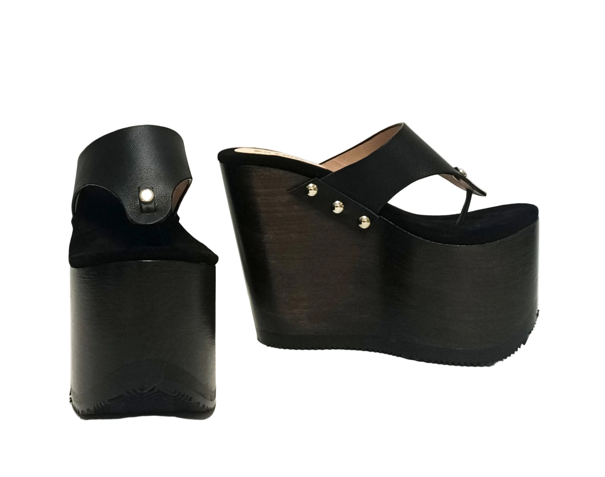 Pair of Sol Caleyo Kauai XL handcrafted flip flop sandals featuring black genuine leather straps, silver studs, and a high wengue-colored wooden platform sole.