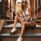 Model wearing custom-made White Western Sandals, highlighting the artisanal wood craftsmanship and extreme platform height in an urban setting.