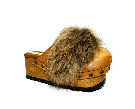 Hand-aged sand leather wedge mule clogs with natural fur trim and gold-tone studs by Sol Caleyo