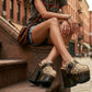 Handmade snake print leather mule clogs with brown straps, antique brass buckle and 17 cm dark wenge wooden heel by Sol Caleyo.