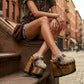 Profile view of Route 66 XL Snake Natural clogs with 17cm natural wood platform heel, snake print leather, and antique brass buckle.