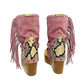 Handmade Atenea Pink Flip Flop Boots by Sol Caleyo, featuring pink suede leather, fringe details, shells, vintage coins, and a high wooden platform sole on a white background