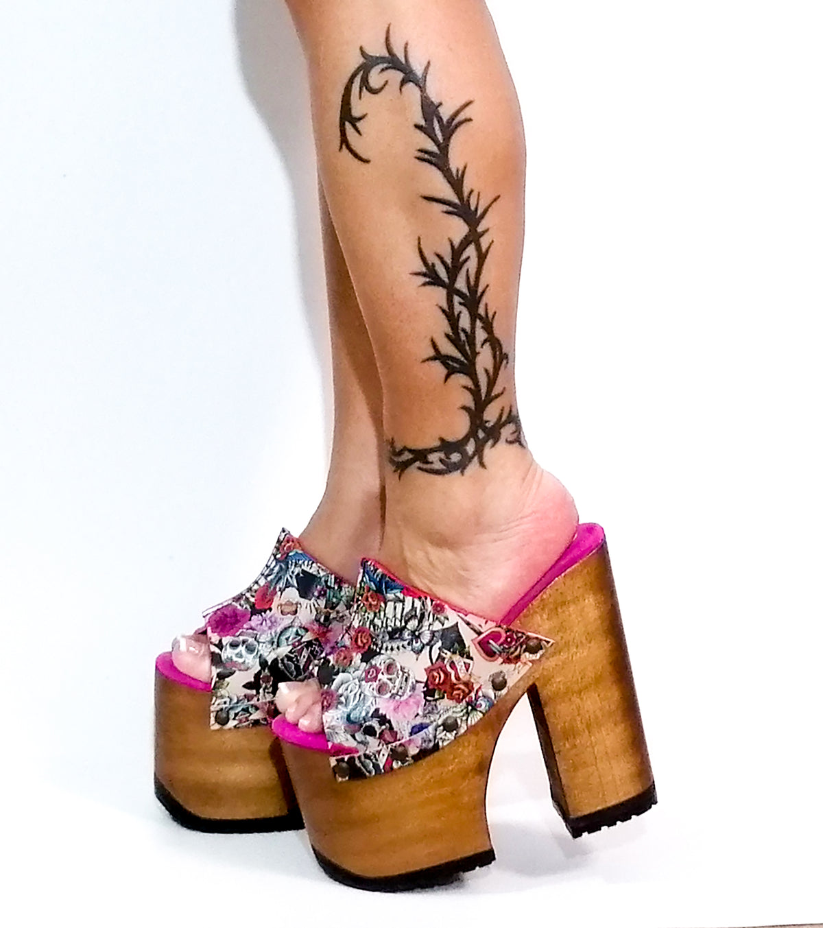 Handmade pink tattoo print leather open toe platform mule sandals with wide strap, old-gold studs and 17 cm natural lacquered straight wooden heel by Sol Caleyo.
