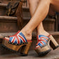 Handmade UK flag patchwork leather open toe wide strap platform mule sandals with antique gold studs and 13 cm wooden heel by Sol Caleyo.