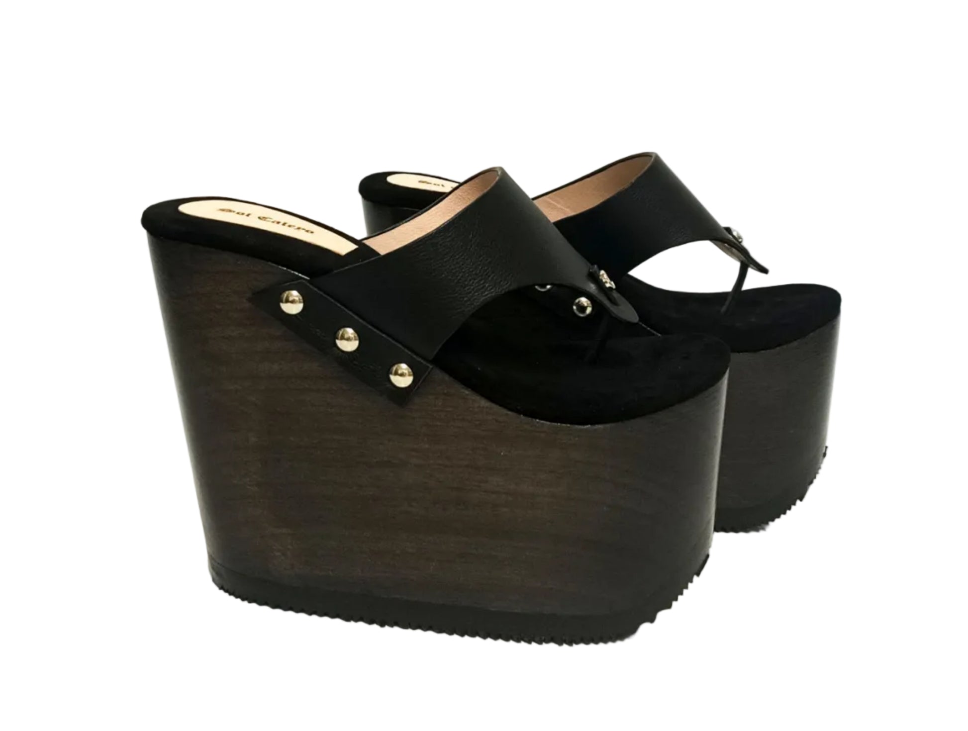 Pair of Sol Caleyo Kauai XL handcrafted flip flop sandals featuring black genuine leather straps, silver studs, and a high wengue-colored wooden platform sole.