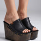 Vintage 70s-style black leather clogs with super high wooden wedge heels. Handmade to order.
Available in sizes 34 to 47.
An exclusive design by Sol Caleyo, created for those who value craftsmanship, comfort, and authentic style.