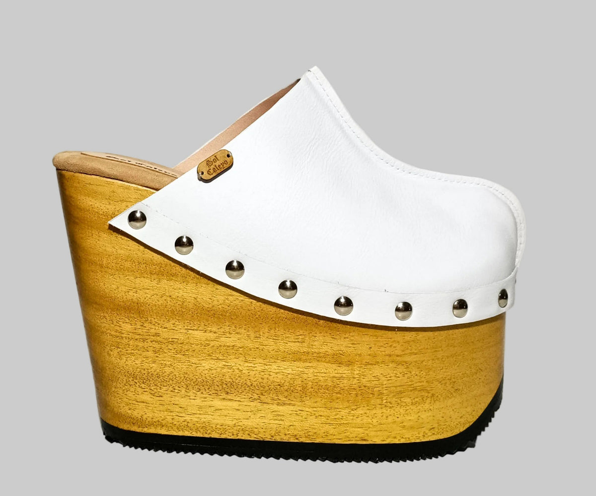 Handmade white leather open-back wedge mule clogs with silver studs and 15 cm light wooden wedge by Sol Caleyo.