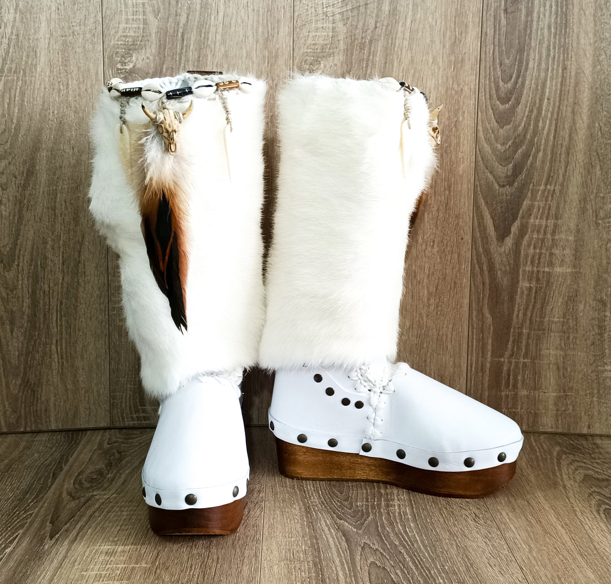 White handmade boho leather and rabbit fur wedge boots with carved bone, shells and feathers by Sol Caleyo