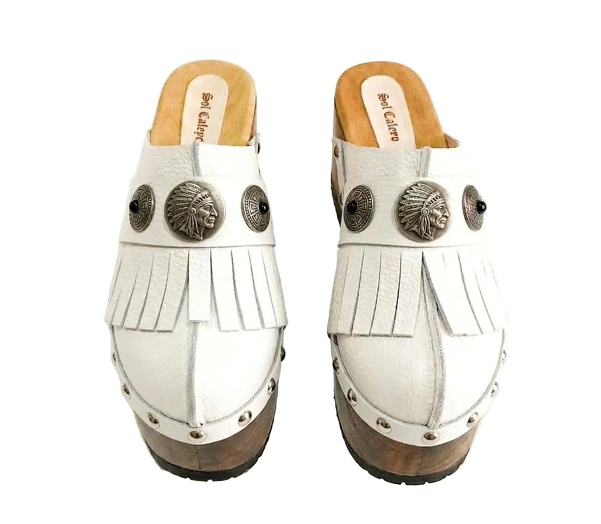 Side view of White Indian Clogs XL featuring extreme 17cm natural wood platform, white leather fringes, and antique silver metal conchos.