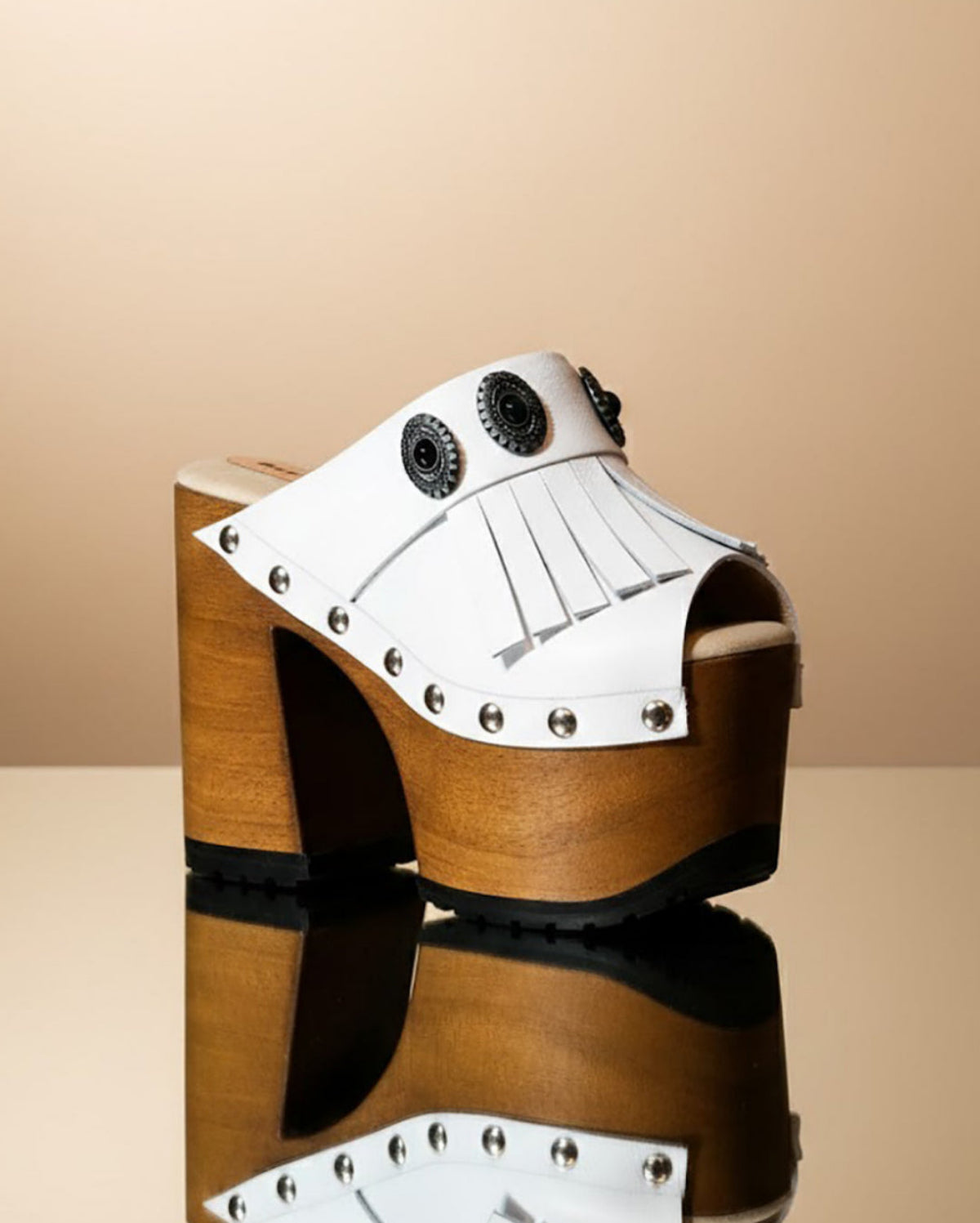 White handmade leather boho platform mule sandals with fringe, silver conchos and 14 cm wooden heel by Sol Caleyo